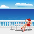 woman in a red dress and hat sits on a chair in a summer cafe on the embankment near the sea Royalty Free Stock Photo