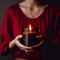 Woman in red dress holding burning candle, design and branding ready candle jar mockup with female hands, no face Royalty Free Stock Photo