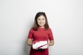 Woman in a red dress holding gift box on white Royalty Free Stock Photo