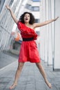 Woman in red dress jump