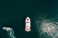 Woman in a red dress lies on the prow of a white motor yacht sailing on the sea. View from above Royalty Free Stock Photo