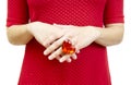 Woman in a red dress shows a ring with a huge ruby colored heart-shaped plastic gem Royalty Free Stock Photo