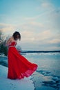 Woman in red dress. Siberia, ice water, winter, very cold