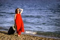 Woman in red dress with suitcase sea Royalty Free Stock Photo