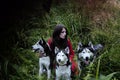 woman in red dress with tree wolfs, forest, husky dogs mystery portrait