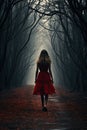 A Woman in red dress walking on a dark path in a strange dark forest with fog Royalty Free Stock Photo