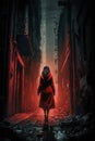 Woman in a red dress walking down a grungy alley. Royalty Free Stock Photo