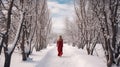 A Woman in red dress walking on a path in Winter landscape with fair trees under the snow. Scenery for the tourists. Christmas