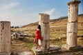 Woman in a red dress walks through Pamukkale, Turkey. Beautiful view of the sights Royalty Free Stock Photo