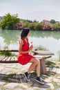 Woman in a red dress walks through Pamukkale, Turkey. Beautiful view of the sights Royalty Free Stock Photo