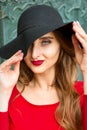 Woman in red dress wearing black hat Royalty Free Stock Photo