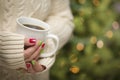 Woman with Red and Green Manicure Holding Cup of Coffee Royalty Free Stock Photo