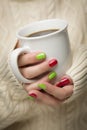 Woman with Red and Green Nail Polish Holding Cup of Coffee Royalty Free Stock Photo