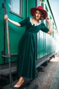 Woman in red hat against old railway wagon