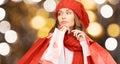 Woman in red hat and scarf holding shopping bags Royalty Free Stock Photo