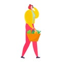 Woman with red hat and yellow jacket carries a shopping basket with vegetables. Groceries shopping, healthy food concept