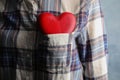 Woman with red heart in pocket, closeup.