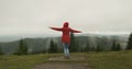 woman in a red jacket got lost in the mountains. He waves his arms, jumps and signals his whereabouts. Carpathians