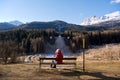 Woman in a red jacket looking at the abandoned ski jump Royalty Free Stock Photo