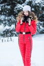 Woman in a red jumpsuit in the winter Royalty Free Stock Photo