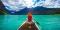 A woman in red life jacket canoeing in Lake Louise with torquoise lake and bluesky Royalty Free Stock Photo