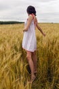 Woman in a red light dress stands in a field Royalty Free Stock Photo