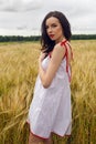 Woman in a red light dress stands in a field Royalty Free Stock Photo