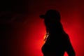 Woman, red light and silhouette at party concert or festival night, stage event or dark. Female person, strobe and glow Royalty Free Stock Photo