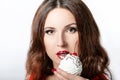 Woman with red lips eating a cake with cream and a cherry on the light background. Delicious cupcake in a womans hand. Lips in a Royalty Free Stock Photo