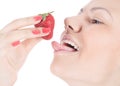 Woman with red lips eating a strawberry Royalty Free Stock Photo