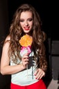 Beautiful woman with red lips eats a big candy sweet lollipop Royalty Free Stock Photo