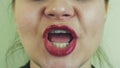 Woman with red lips emphatically sing song in front camera. Mouth. Teeth. Face