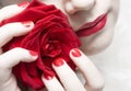 Woman with red lips, nails and rose