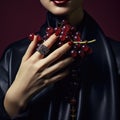 A woman with red lips and red nails holding a bunch of grapes, AI