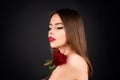 Woman with red lips and rose flower on black isolated background. Fashion beauty portrait on studio background. Royalty Free Stock Photo