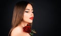Woman with red lips and rose flower on black isolated background. Fashion beauty portrait on studio background. Royalty Free Stock Photo