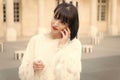 Woman with red lips talk on smartphone in paris, france. Woman with brunette hair hold mobile phone. Beauty girl with Royalty Free Stock Photo