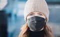 Woman with red long hair, blue eyes, young with FFP2 mask, wearing beige cap and black sweater, head portraits Royalty Free Stock Photo