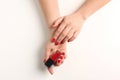 Woman with red manicure holding nail polish bottle on white background Royalty Free Stock Photo