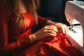 A woman with red manicured hands expertly sews, turning fashion ideas into reality Royalty Free Stock Photo