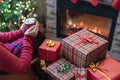 Woman with red mug of hot chocolate and melted marshmallow packing handmade christmas gifts sitting near christmas tree