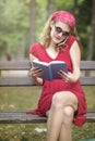 Woman in red reading and telephoning Royalty Free Stock Photo
