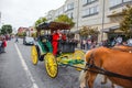 Woman in a red rides an old carriage