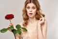 Woman with red rose on a light background surprised look Model Copy Space Royalty Free Stock Photo