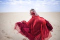 Woman in red. Run away girl in amazing scarlet dress. Royalty Free Stock Photo