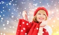 Woman with red shopping bags over snow background Royalty Free Stock Photo