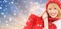 Woman with red shopping bags over snow background Royalty Free Stock Photo