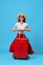 woman in red skirt luggage vacation travel flight destination