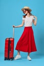 woman in red skirt luggage vacation travel flight destination