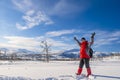 Woman in red sports jacket savors snow and breathtaking Norwegian landscape